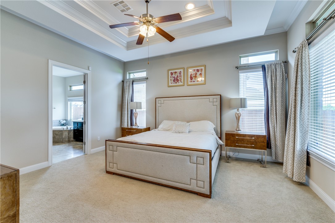 16404 Aventura Avenue Pflugerville, TX 78660 - Photo 11 of 22 a bedroom with a bed and a chandelier
