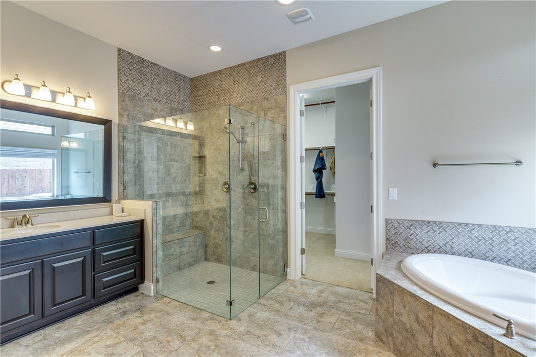 16404 Aventura Avenue Pflugerville, TX 78660 - Photo 12 of 22 a bathroom with a sink a toilet and shower