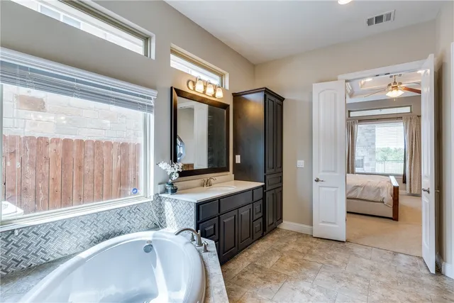 a bathroom with a sink and a large mirror