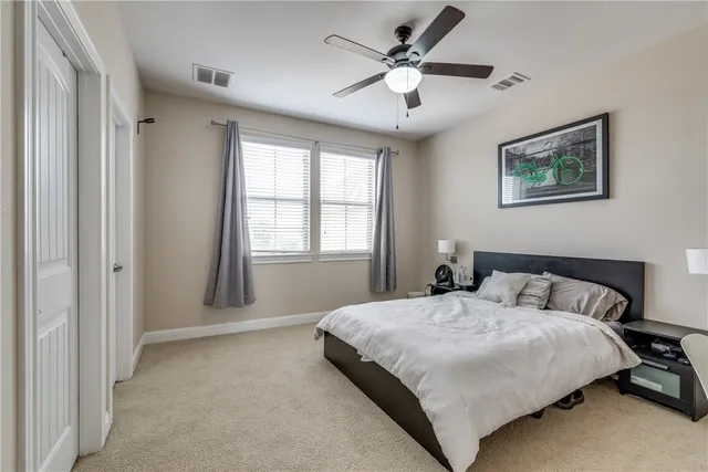 a bedroom with a large bed and a window