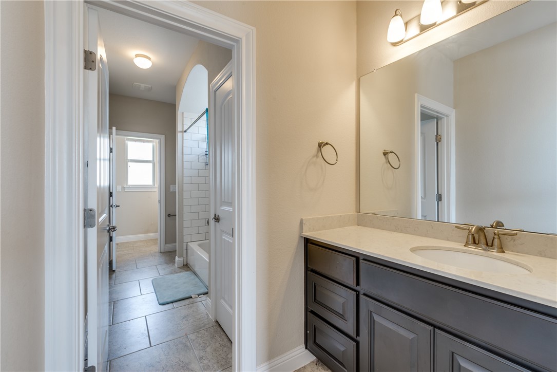 16404 Aventura Avenue Pflugerville, TX 78660 - Photo 17 of 22 a bathroom with a sink a toilet and shower