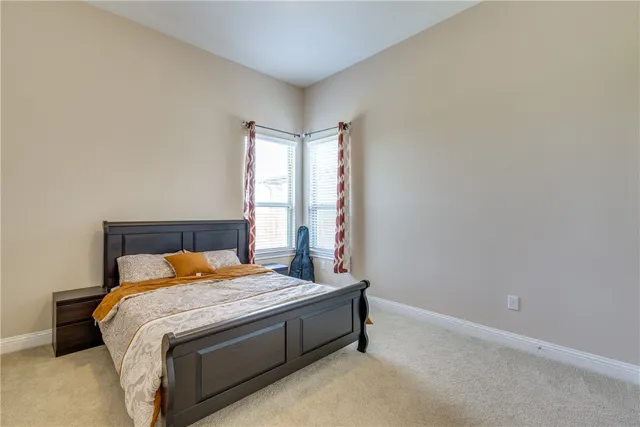 a bedroom with a bed and window