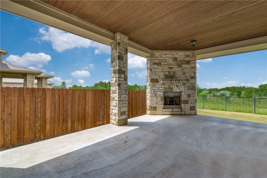 16404 Aventura Avenue Pflugerville, TX 78660 - Photo 21 of 22 a view of an empty room with a fireplace and a ceiling fan