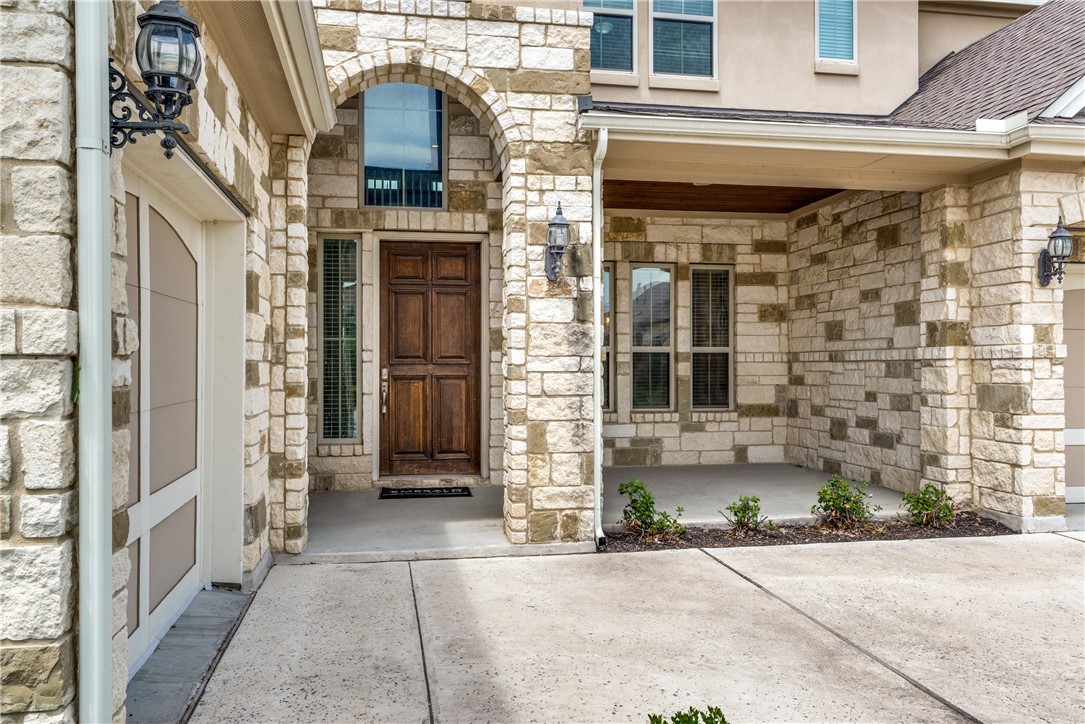 16404 Aventura Avenue Pflugerville, TX 78660 - Photo 3 of 22 a view of a brick house with a large windows