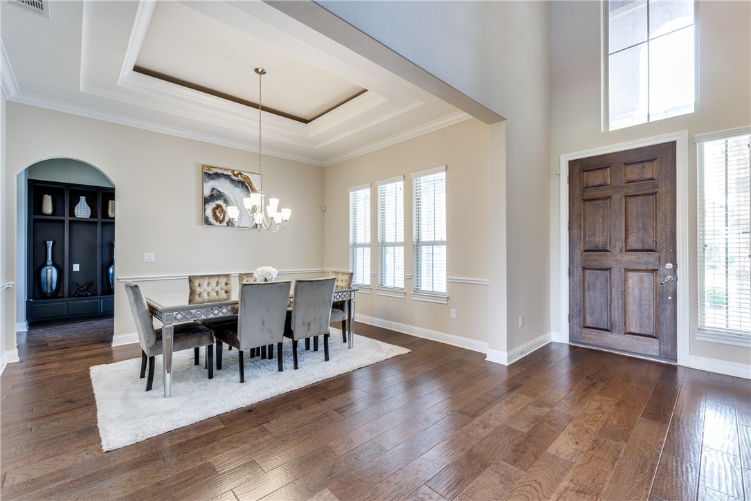 16404 Aventura Avenue Pflugerville, TX 78660 - Photo 4 of 22 a view of a dining room with furniture and wooden floor