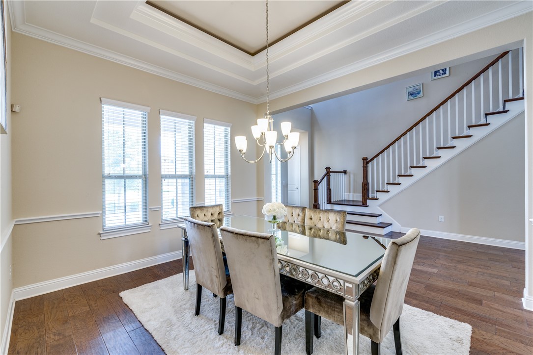16404 Aventura Avenue Pflugerville, TX 78660 - Photo 5 of 22 a view of a dining room with furniture window and wooden floor