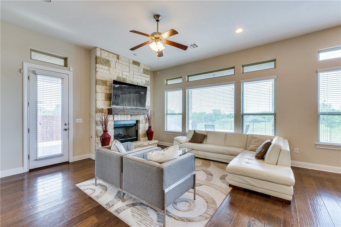 16404 Aventura Avenue Pflugerville, TX 78660 - Photo 6 of 22 a living room with furniture large window and wooden floor
