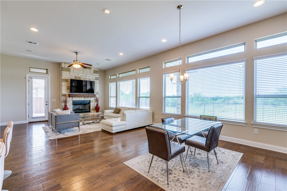 16404 Aventura Avenue Pflugerville, TX 78660 - Photo 7 of 22 a view of a dining room with furniture window and wooden floor