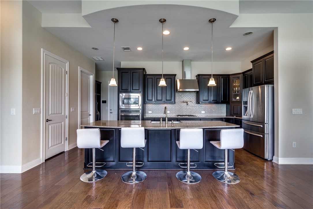 16404 Aventura Avenue Pflugerville, TX 78660 - Photo 9 of 22 a kitchen with a sink cabinets and wooden floor