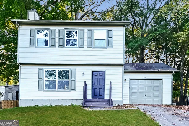 a front view of a house with a garden