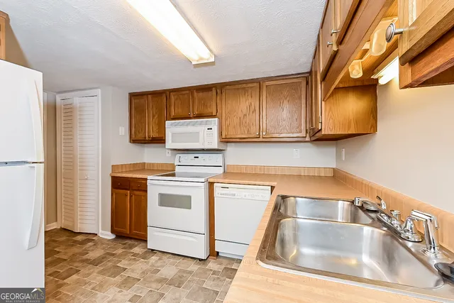 a kitchen with a sink cabinets and stainless steel appliances