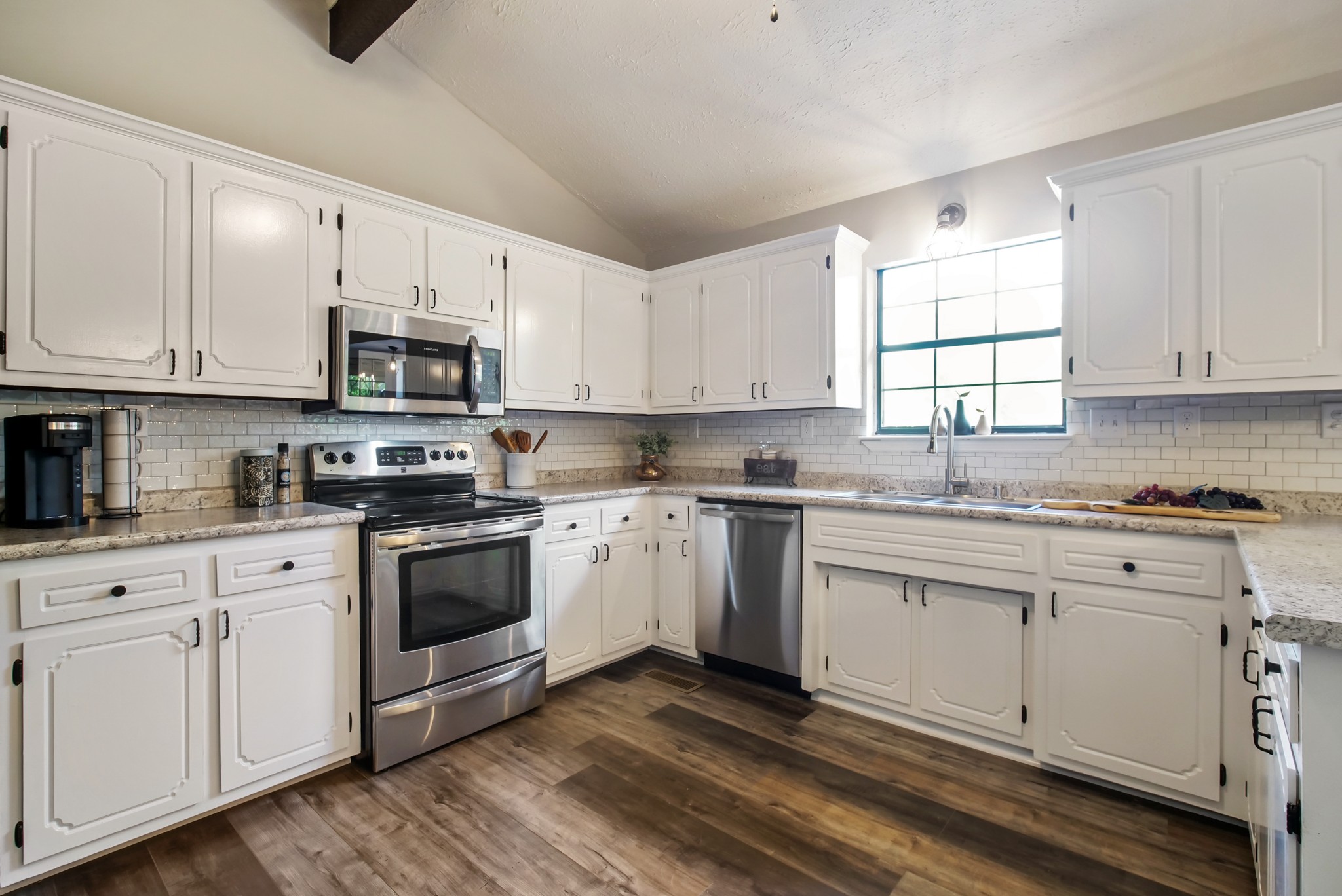3977 Cairo Bend Road Lebanon, TN 37087 - Photo 20 of 39 a kitchen with cabinets appliances a sink and a window