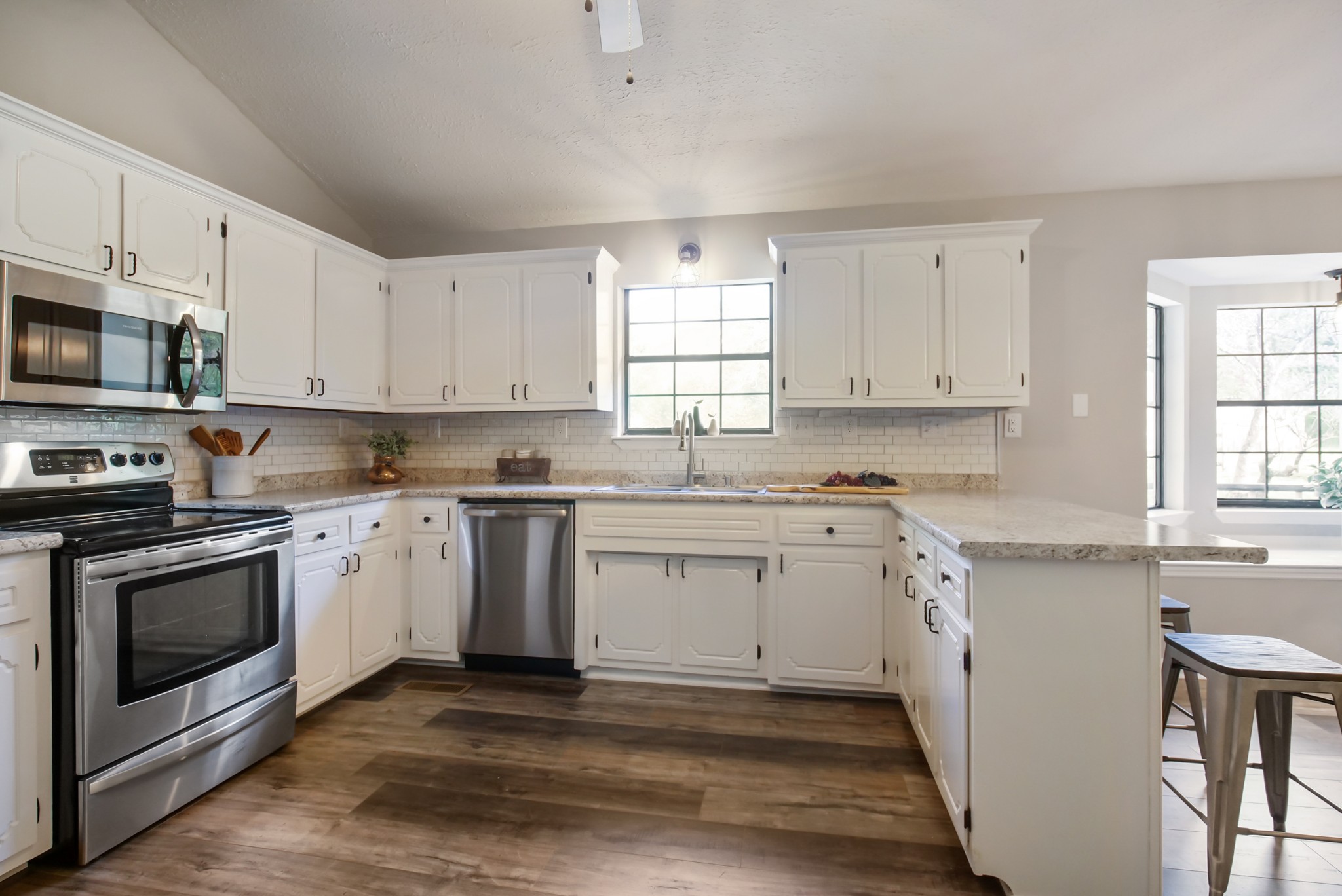 3977 Cairo Bend Road Lebanon, TN 37087 - Photo 21 of 39 a kitchen with granite countertop white cabinets stainless steel appliances a sink and a window