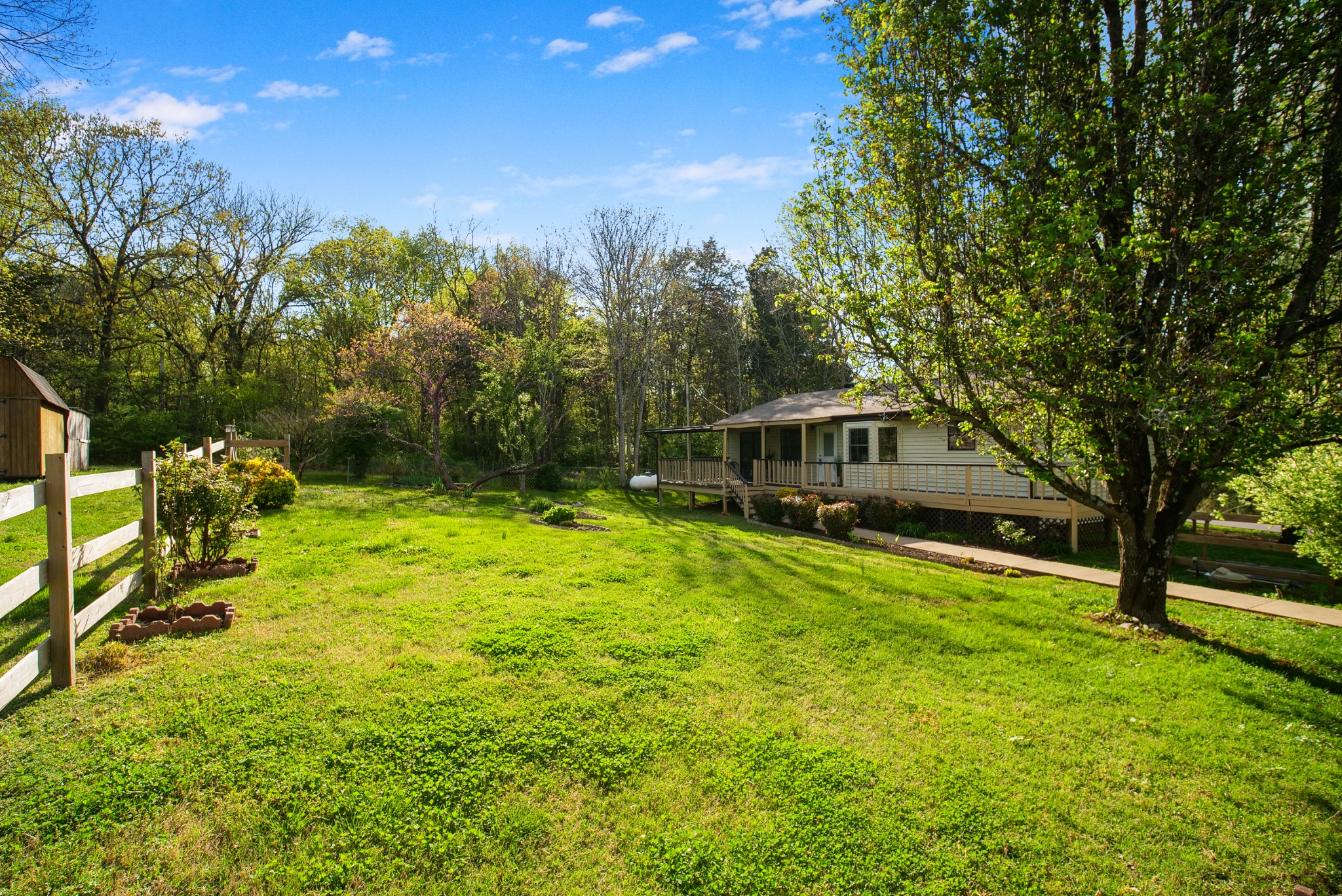 3977 Cairo Bend Road Lebanon, TN 37087 - Photo 7 of 39 a yellow house with trees in front of it