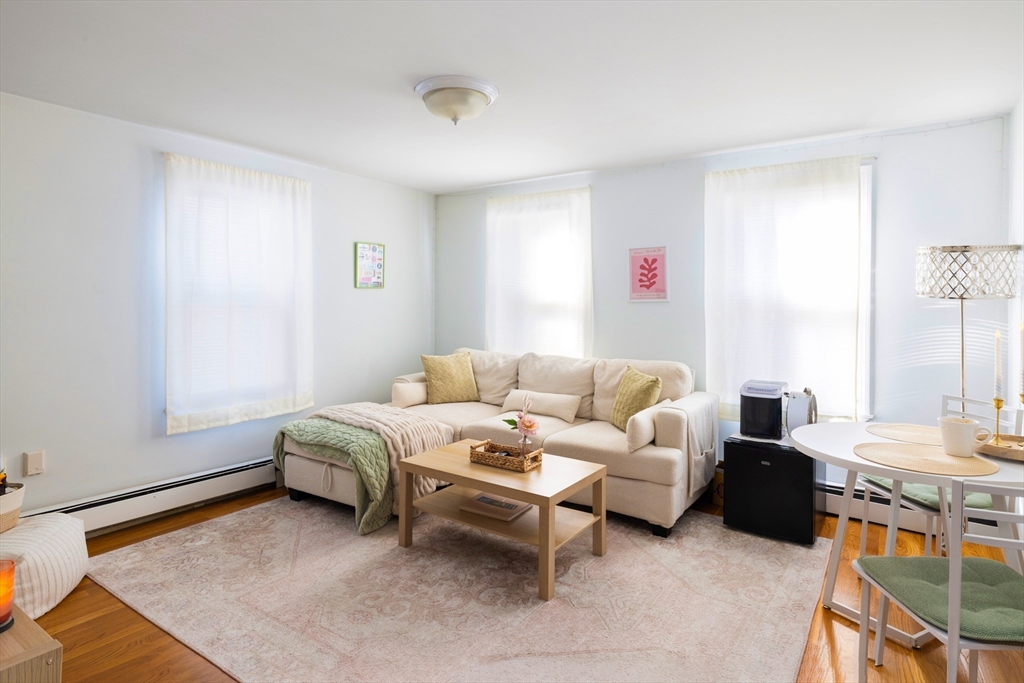 140 Athens Street Boston, MA 02127 - Photo 2 of 11 a living room with furniture and a flat screen tv