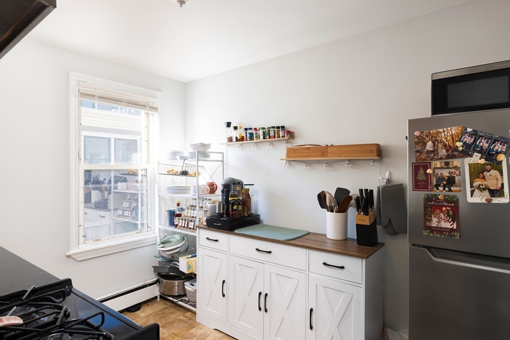 140 Athens Street Boston, MA 02127 - Photo 3 of 11 a kitchen with a sink a stove and cabinets
