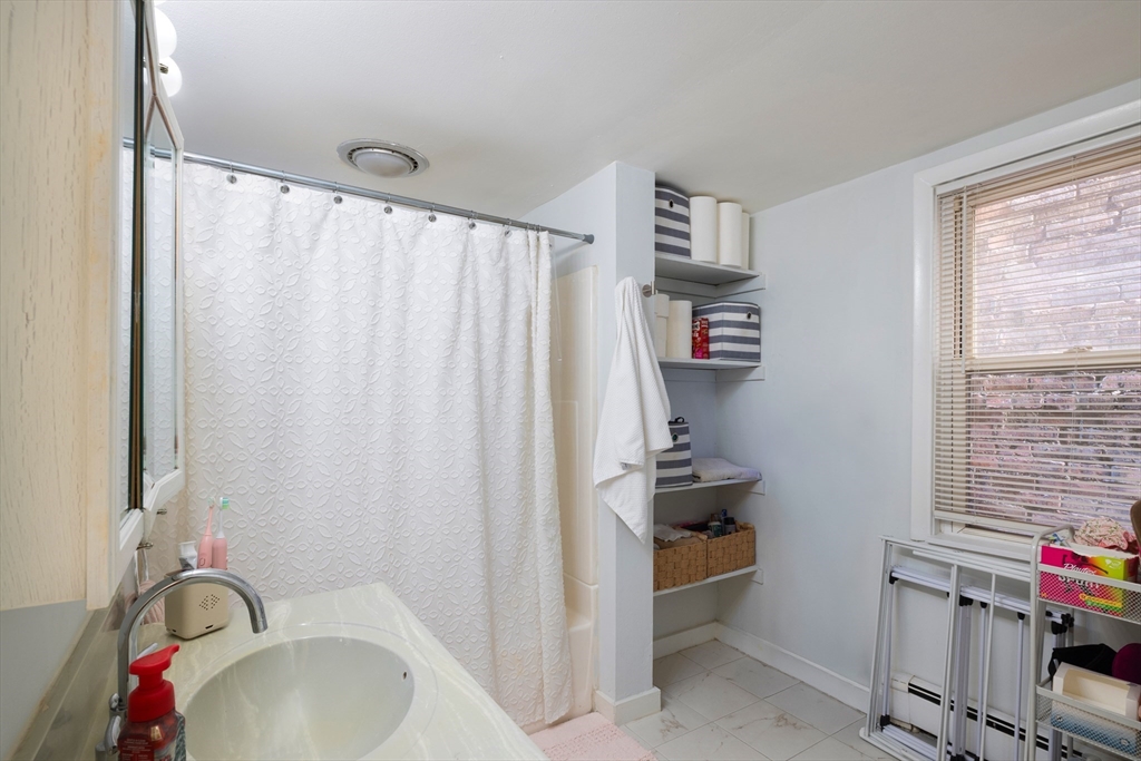 140 Athens Street Boston, MA 02127 - Photo 5 of 11 a bathroom with a sink and a tub