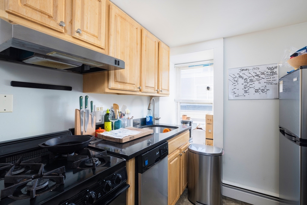 140 Athens Street Boston, MA 02127 - Photo 7 of 11 a kitchen with stainless steel appliances a stove a refrigerator and a sink