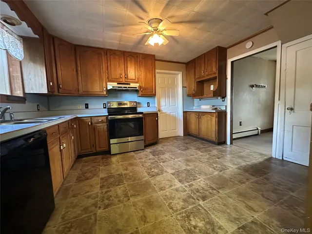 a kitchen with stainless steel appliances granite countertop a stove sink and cabinets