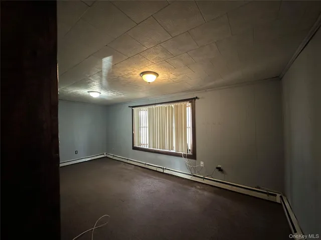 an empty room with a empty space and windows