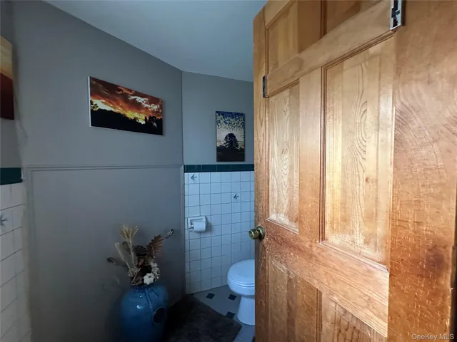 a bathroom with a granite countertop toilet and a sink