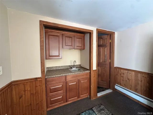 a hallway with a sink and cabinets
