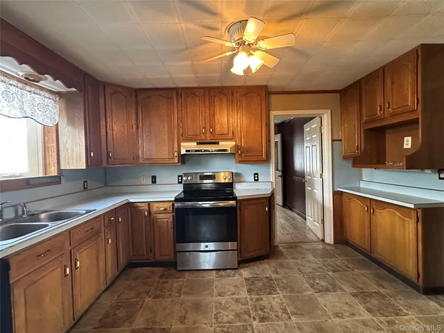 a kitchen with stainless steel appliances granite countertop a stove a sink dishwasher and a refrigerator