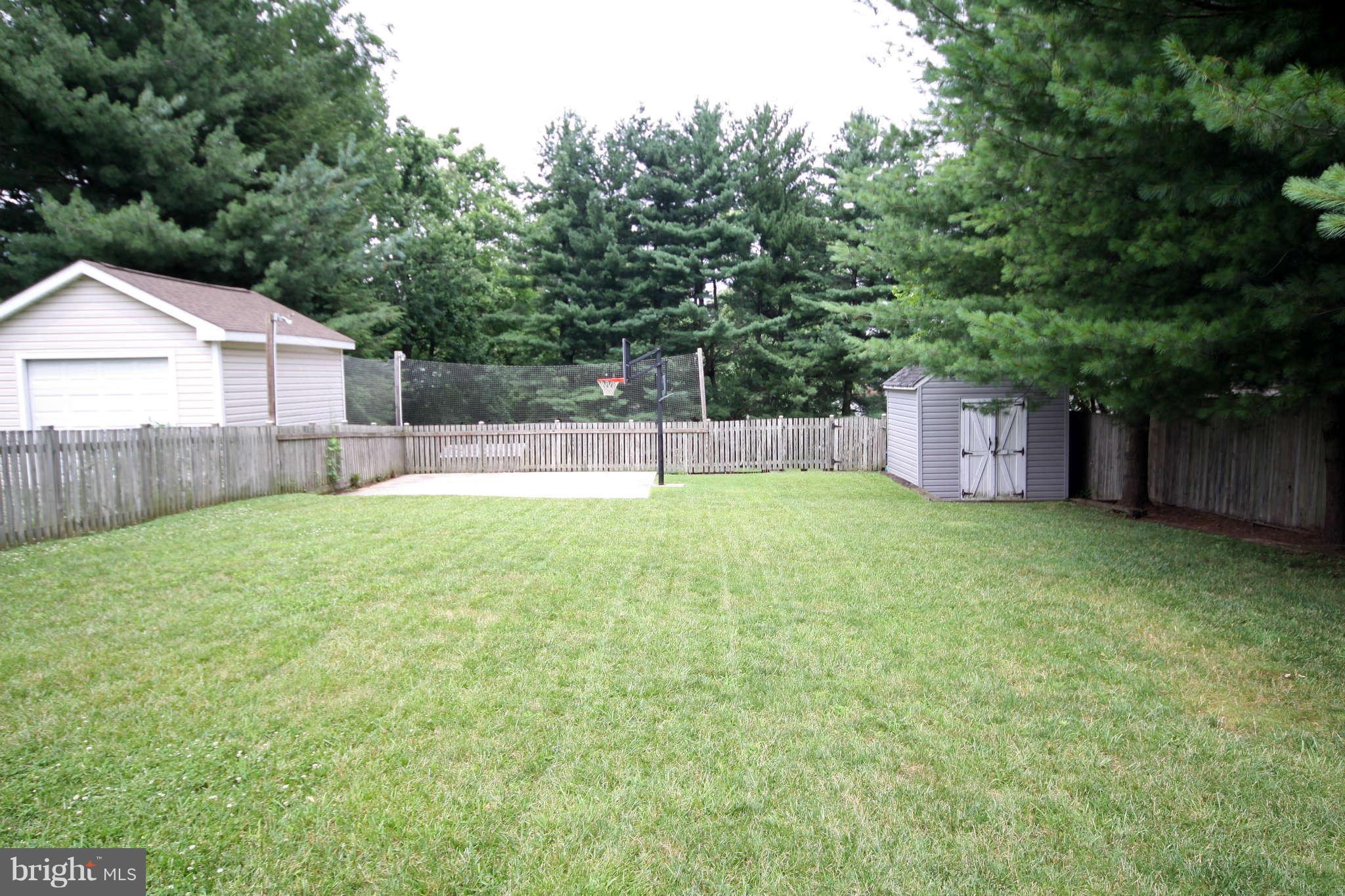 603 Academy Road Baltimore, MD 21228 - Photo 29 of 30 a view of a backyard with a small cabin and wooden fence