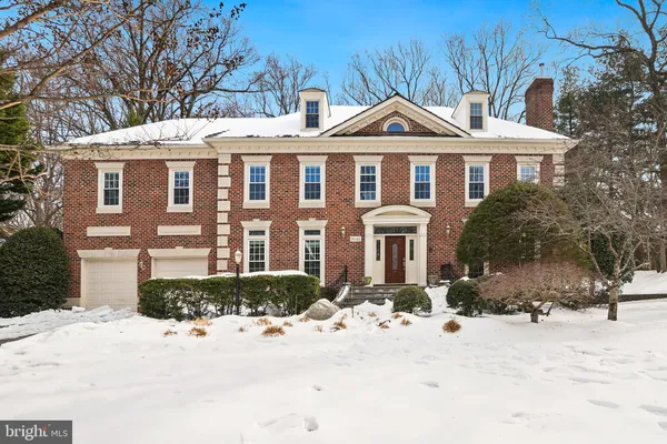 a living room with furniture and floor to ceiling windows