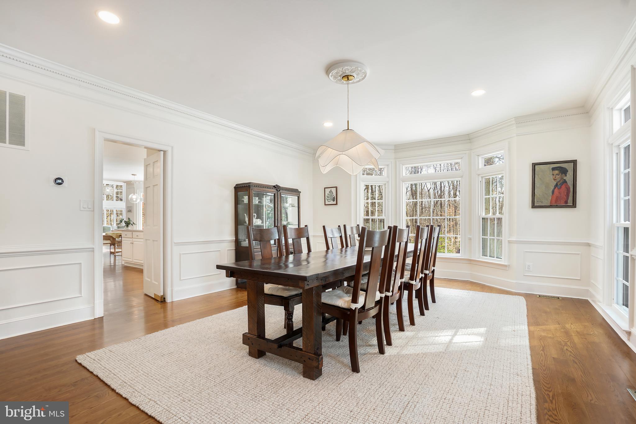 9646 Eagle Ridge Drive Bethesda, MD 20817 - Photo 11 of 75 a dining room with furniture wooden floor a rug and a chandelier