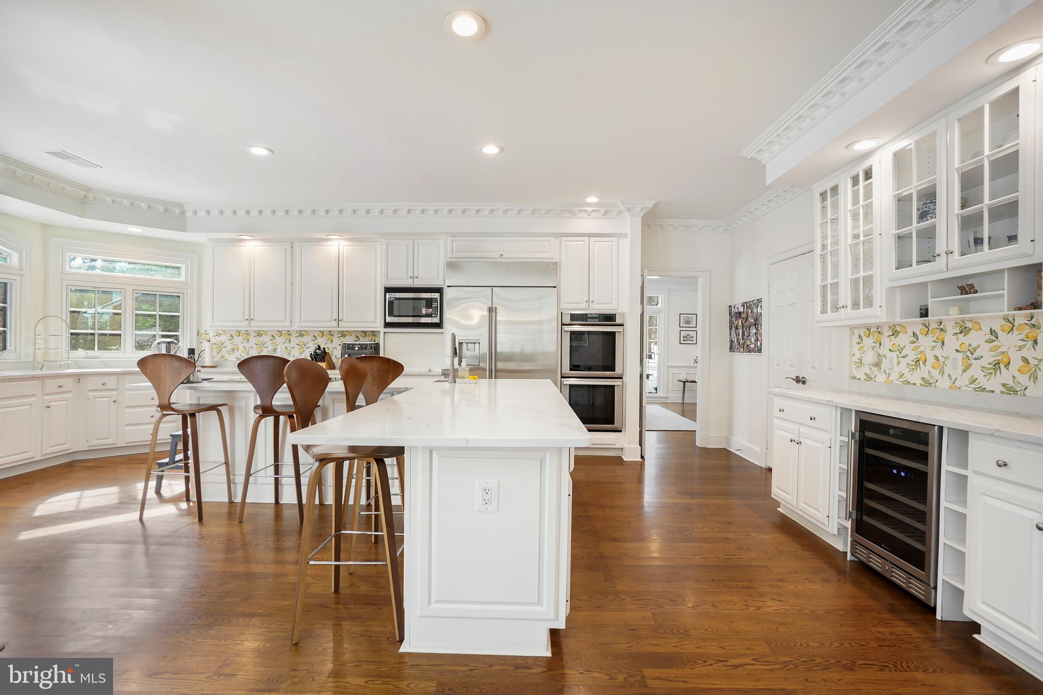 9646 Eagle Ridge Drive Bethesda, MD 20817 - Photo 13 of 75 a open kitchen with white cabinets and stainless steel appliances