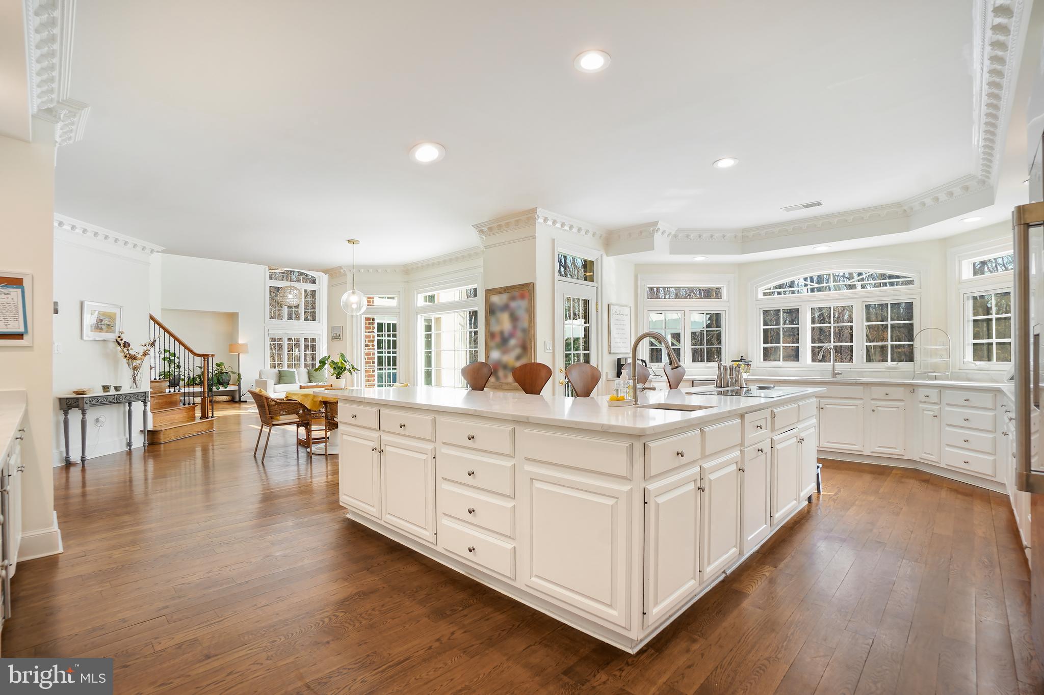 9646 Eagle Ridge Drive Bethesda, MD 20817 - Photo 16 of 75 a large white kitchen with lots of counter space and a wooden floors