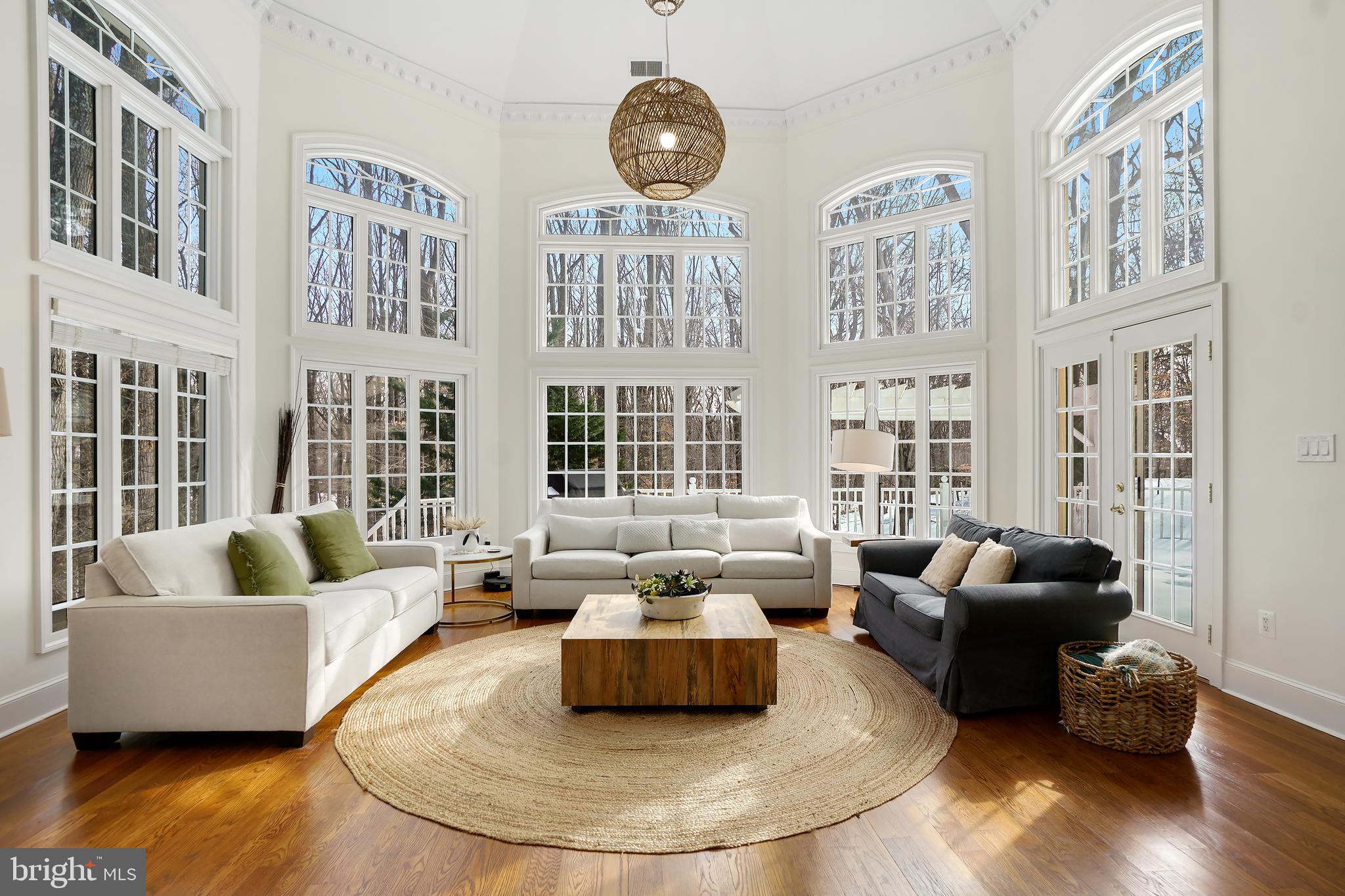 9646 Eagle Ridge Drive Bethesda, MD 20817 - Photo 2 of 75 a living room with furniture and floor to ceiling windows