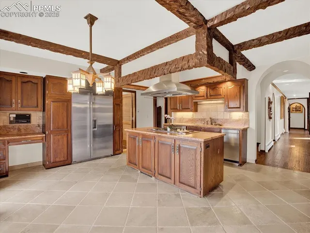 a large kitchen with cabinets and stainless steel appliances
