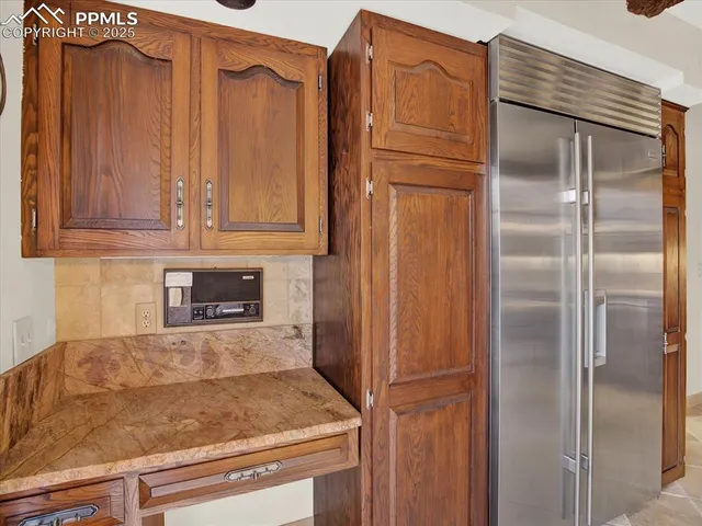 a kitchen with stainless steel appliances granite countertop a refrigerator and cabinets