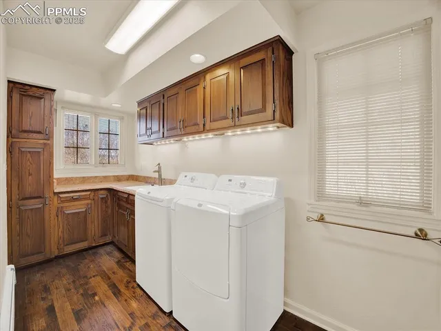 a utility room with cabinets washer and dryer