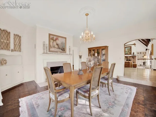 a view of a dining room with furniture wooden floor and chandelier