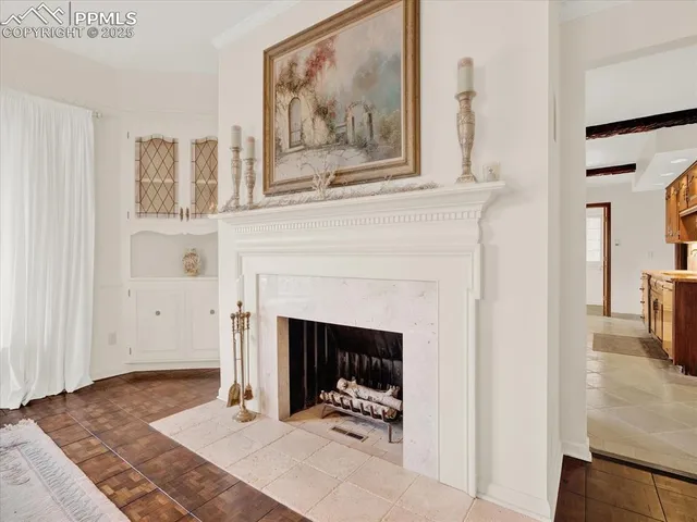a view of a livingroom with a fireplace and cabinet