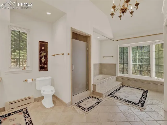 a spacious bathroom with a toilet sink and mirror