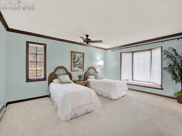 a spacious bedroom with two beds and a window