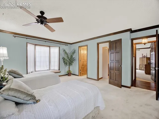 a bedroom with a bed and a large mirror