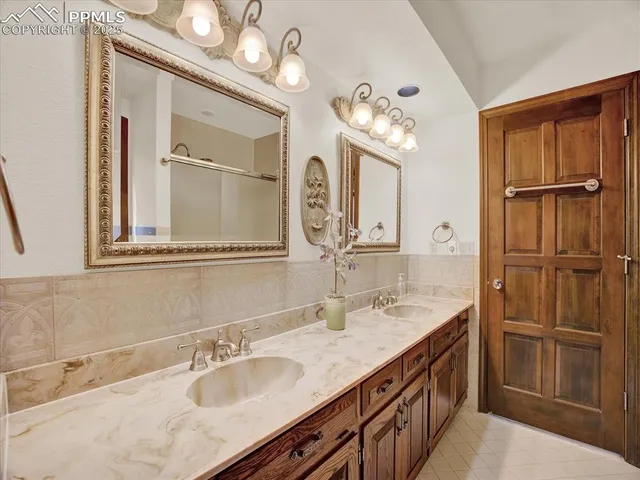 a bathroom with a sink double vanity and a mirror