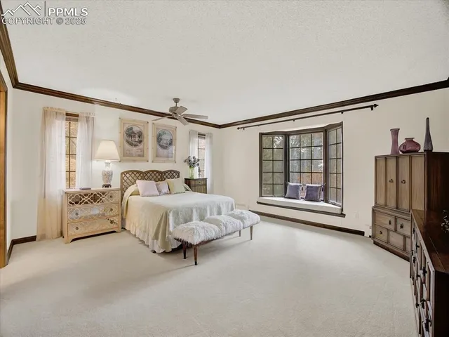 a spacious bedroom with a bed couch and a window