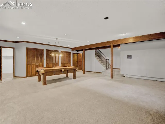 an empty room with wooden floor and furniture