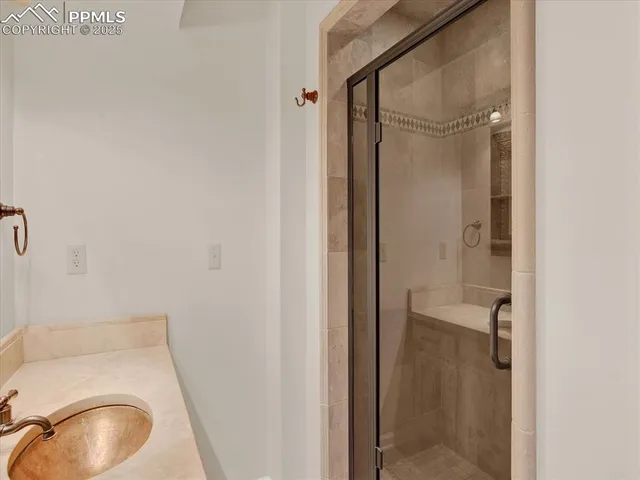 a bathroom with a granite countertop sink toilet and shower