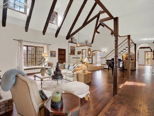 a living room with fireplace furniture and a table