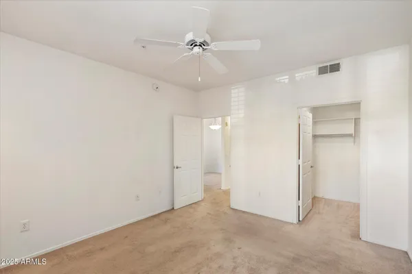 an empty room with a ceiling fan and a ceiling fan