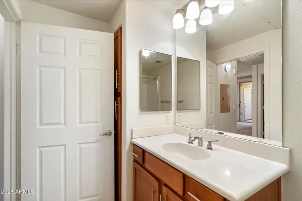 a bathroom with a sink vanity and a mirror