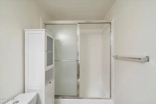 a bathroom with a glass shower door