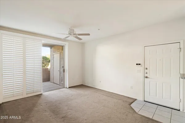 a view of a livingroom with a ceiling fan and window